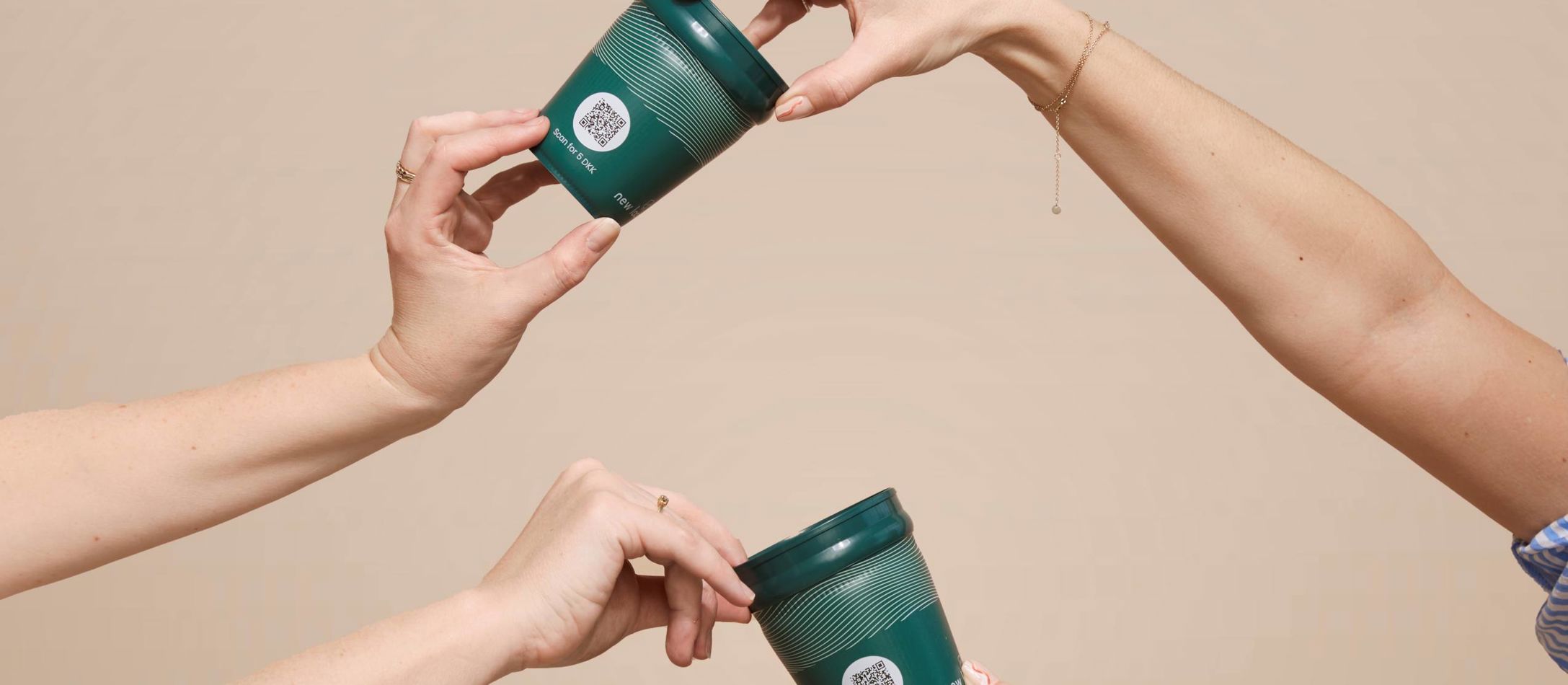 Flere hænder der holder pantkopper fra New Loop